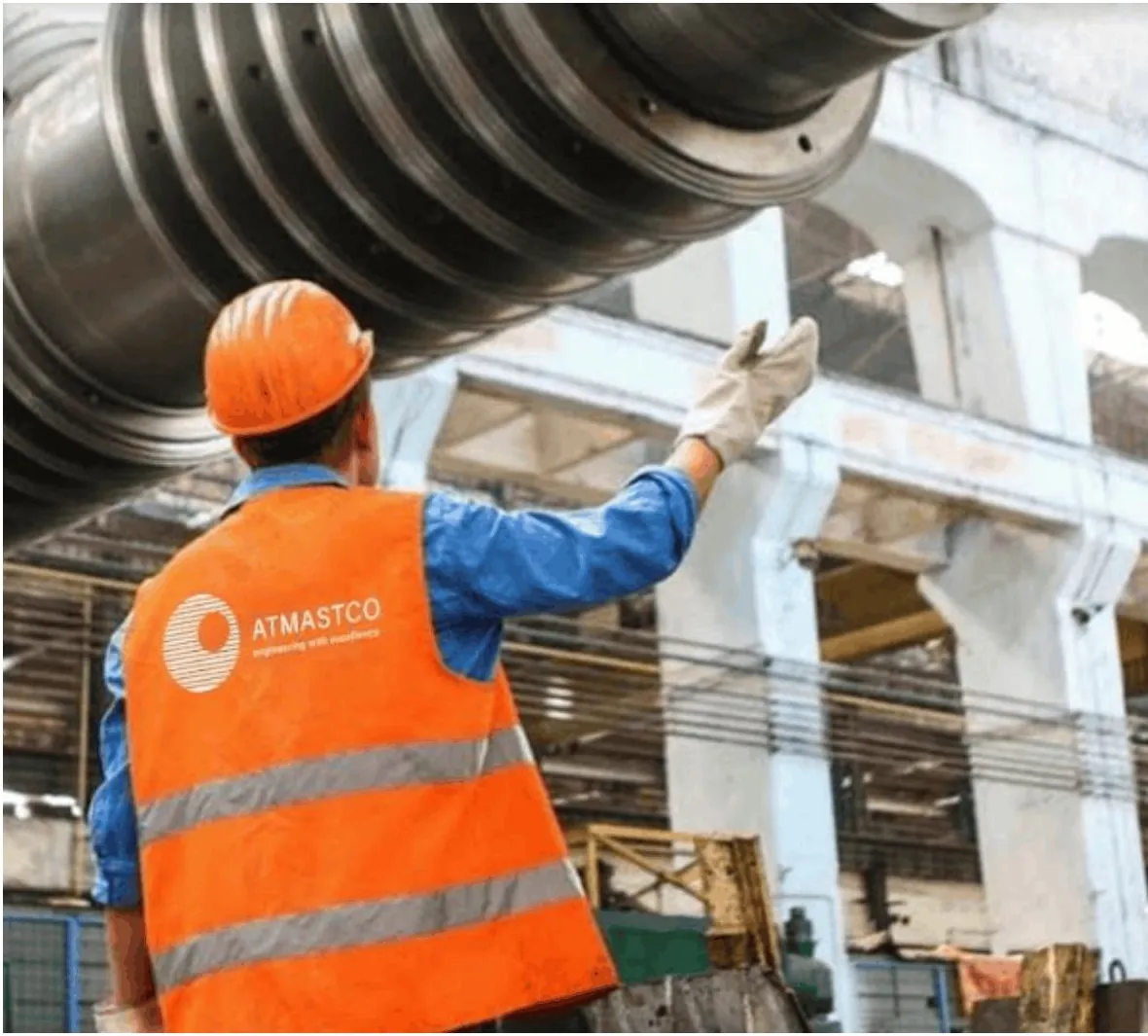 Worker in a high-visibility vest carrying the Atmastco logo